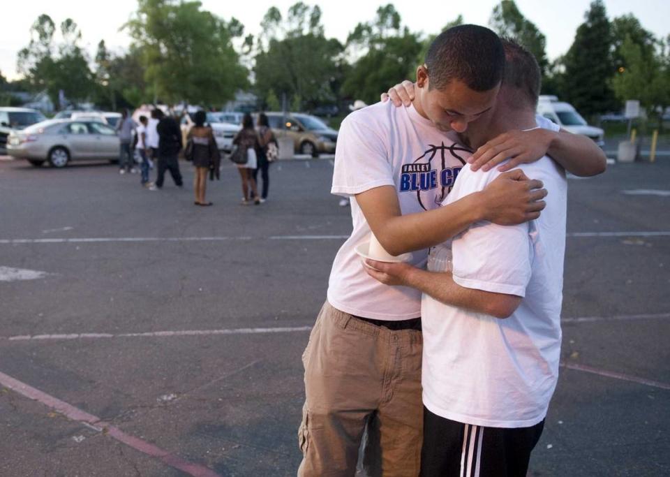 Valley High School basketball player Andre Bobbit consoles coach Mathew Bradley on June 6, 2010 for D’andre Blackwell. Blackwell, a Valley graduate and standout on the basketball team, was fatally shot at a graduation party late.