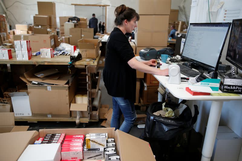 An employee prepares an order for Amazon at Porona warehouse in Bruay-sur-l'Escaut