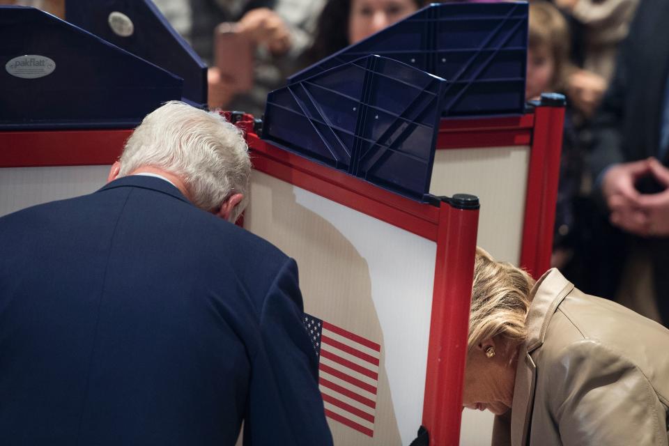 Former US President Bill Clinton (L) and Democratic presidential nominee Hillary Clinton (R)vote at Douglas G. Griffin School in Chappaqua, New York, on Nov. 8.