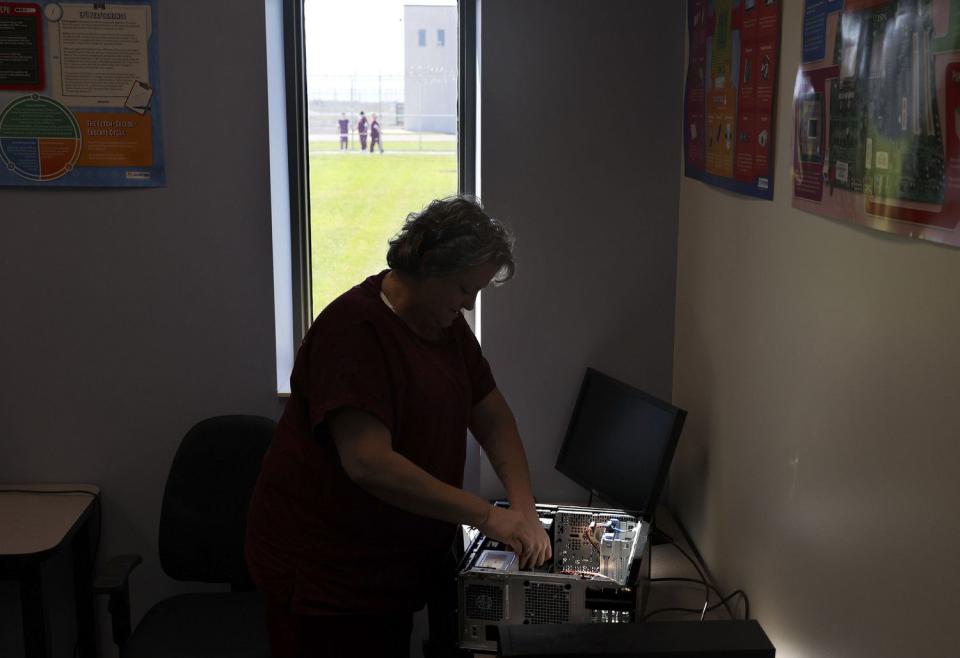 Heidi Rasmussen fixes a computer in her information technology class at the Utah State Correctional Facility in Salt Lake City on Friday.