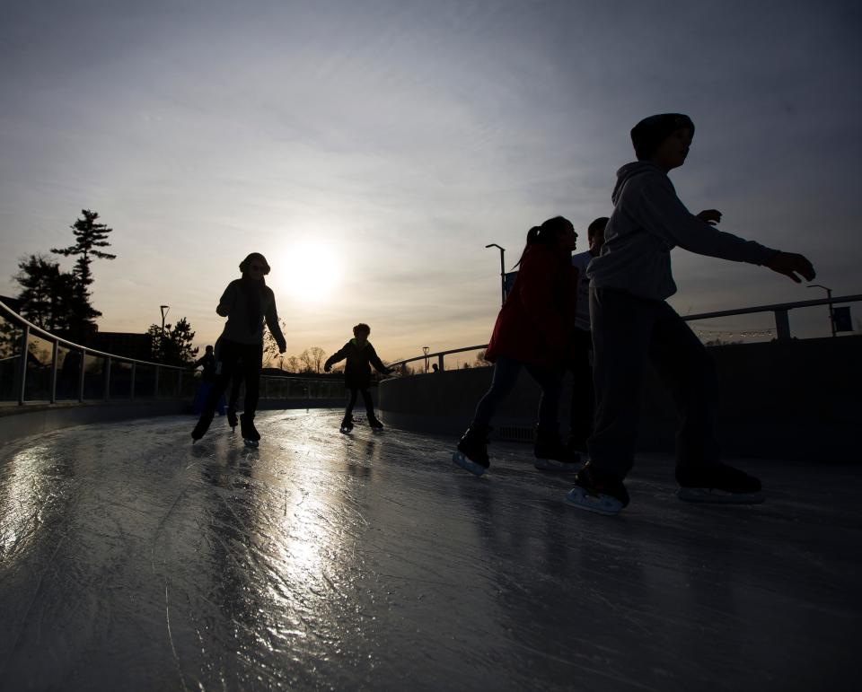 Skaters make their way around the ice Monday, Dec. 23, 2019 at Howard Park in South Bend.