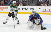 Colorado Avalanche goaltender Alexandar Georgiev, right, deflects a shot by Dallas Stars left wing Mason Marchment during the first overtime of Game 6 of an NHL hockey playoff series Friday, May 17, 2024, in Denver. (AP Photo/David Zalubowski)