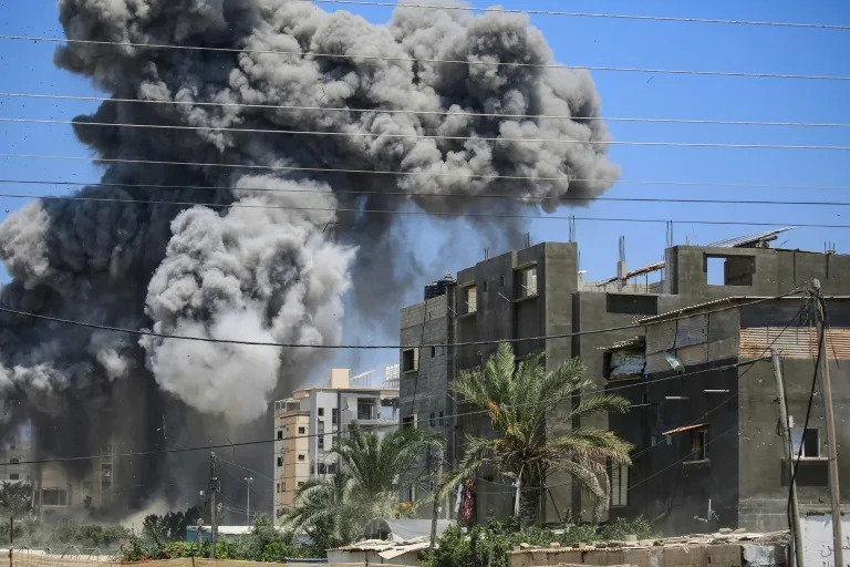 Smoke rises from a building hit by an Israeli strike in Nuseirat in the central Gaza Strip on July 20, 2024 (Eyad BABA)