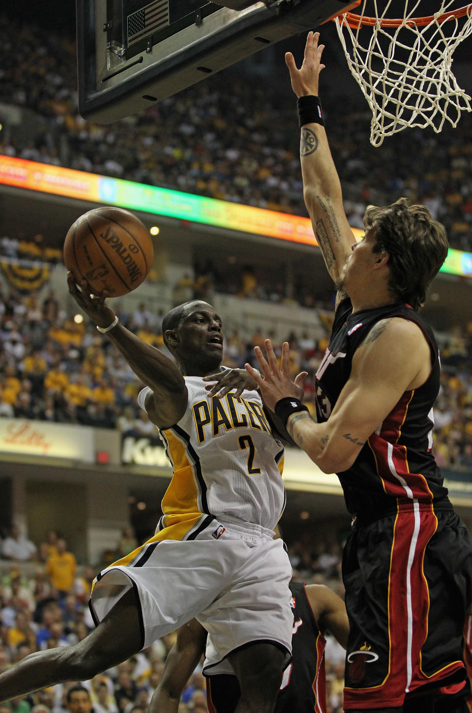 INDIANAPOLIS, IN - MAY 20: Darren Collison #2 of the Indiana Pacers leaps to pass around Mike Miller #13 of the Miami Heat in Game Four of the Eastern Conference Semifinals in the 2012 NBA Playoffs at Bankers Life Fieldhouse on May 20, 2012 in Indianapolis, Indiana. NOTE TO USER: User expressly acknowledges and agrees that, by downloading and/or using this photograph, User is consenting to the terms and conditions of the Getty Images License Agreement. (Photo by Jonathan Daniel/Getty Images)