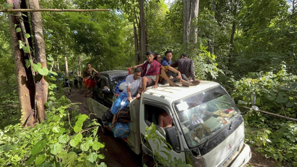 In this photo provided by Free Burma Rangers, villagers in the southern part of Myanmar's eastern state of Kayah flee attacks by the military government's forces on Friday, June 23, 2023. The military government uses air and ground attacks to try to crush the armed resistance that arose after the military seized power from the elected government of Aung San Suu Kyi in February 2021. Fighting has been fierce in southern Kayah, where members of an army-established ethnic Karenni militia recently defected en masse to the resistance side. (Free Burma Rangers via AP)