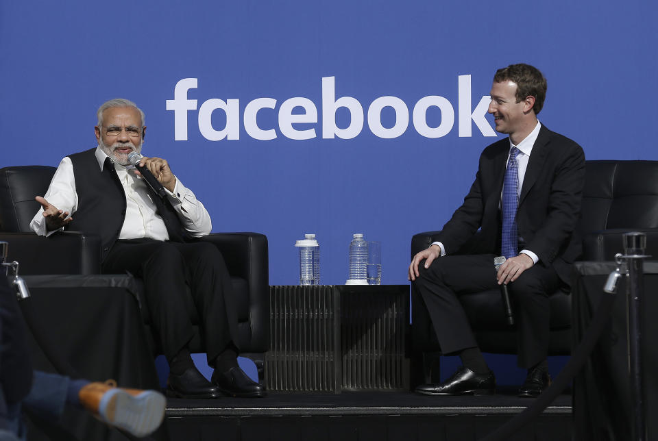 FILE - In this Sept. 27, 2015, file photo, Prime Minister of India Narendra Modi, left, speaks seated next to Facebook CEO Mark Zuckerberg at Facebook in Menlo Park, Calif. Modi, 68, the leader of the Hindu nationalist Bharatiya Janata Party, has carefully constructed an image of himself as a pious man of the people, a would-be monk called to politics who has elevated India’s status globally and transformed its parliamentary elections from a contest of political parties on social and economic issues into a cult of personality. The cult has been fueled by a social media blitzkrieg. There was NaMo TV and a NaMo app. Like President Donald Trump, to whom he is often compared, Modi is a big fan of Twitter, using it and a YouTube channel managed by the BJP to bypass traditional media. (AP Photo/Jeff Chiu, File)