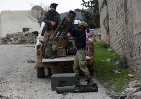 Turkish-backed Free Syrian Army fighter holds a weapon in Northern Afrin countryside, Syria, February 16, 2018. REUTERS/Khalil Ashawi