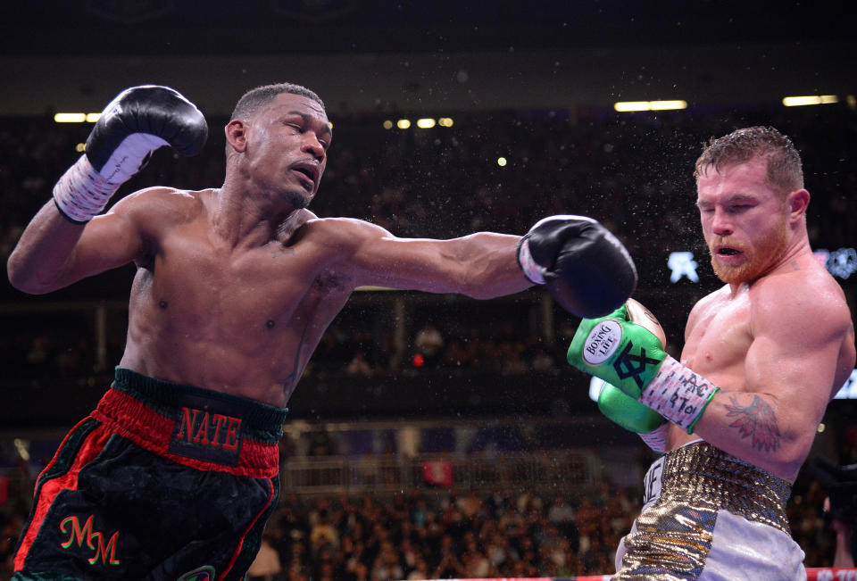 Canelo Alvarez (white trunks) and Daniel Jacobs (black trunks) box during their WBC/WBA/IBF middleweight unification world championship boxing bout at T-Mobile Arena. Alvarez won via unanimous decision. 