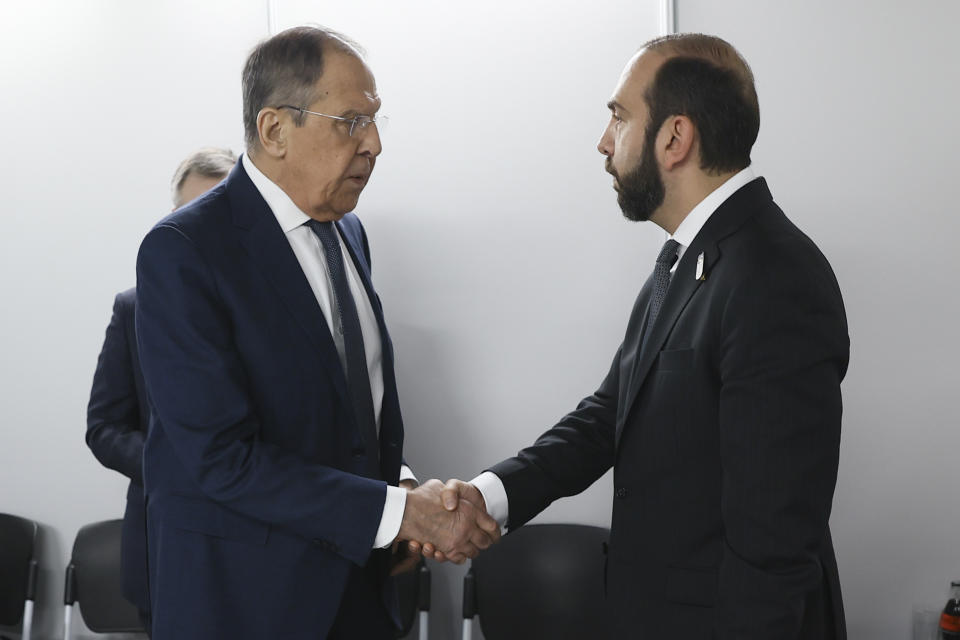 In this photo released by Russian Foreign Ministry Press Service, Russian Foreign Minister Sergey Lavrov, left, shakes hands with Armenia's Foreign Minister Ararat Mirzoyan on the sidelines of the OSCE (Organization for Security and Co-operation in Europe) Ministerial Council meeting, in Skopje, North Macedonia, on Thursday, Nov. 30, 2023. (Russian Foreign Ministry Press Service via AP)