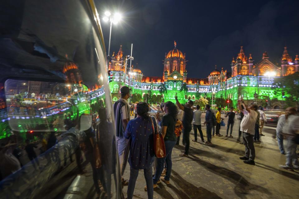 City landmark Chatrapati Shivaji Maharaj terminus building is lit in the colors of the Indian flag on the eve of Independence Day in Mumbai, India, Monday, Aug. 14, 2023. (AP Photo/Rafiq Maqbool)