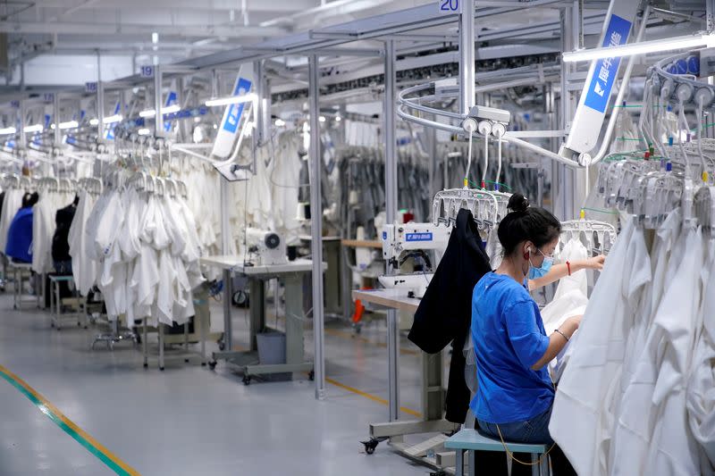 FILE PHOTO: A worker works at Xunxi factory, which is an affiliate of Chinese e-commerce giant Alibaba, during a media tour, in Hangzhou