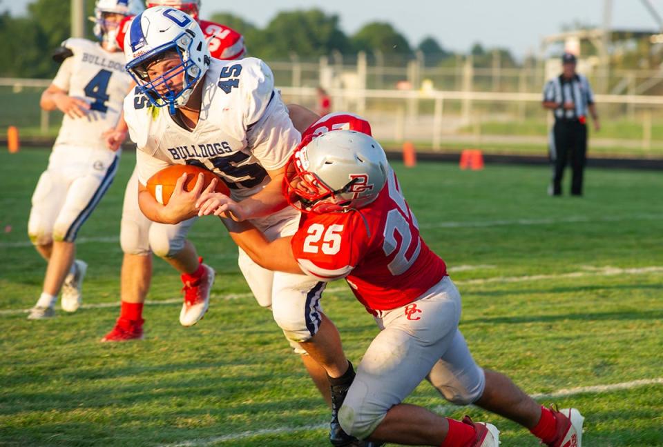 Crestline's Jake Bruce is brought down by Buckeye Central's Manny Mullins.