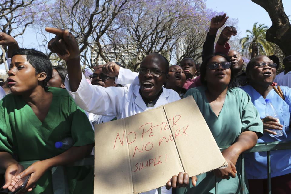 Zimbabwean medical staff march on the streets of Harare, Thursday Sept. 19, 2019. Zimbabwean doctors protesting the alleged abduction of a union leader won a High court ruling allowing them to march and handover a petition to the parliament.The Zimbabwe Hospital Doctors Association has said its president, Peter Magombeyi, was abducted on Saturday after calling for a pay strike, and members say they will not return to work until he is found. (AP Photo/Tsvangirayi Mukwazhi)