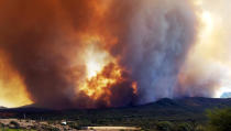 <p>In this Tuesday, June 27, 2017 frame from video, flames and smoke rise from a fire near Mayer, Ariz. The Arizona fire forced the evacuation of Mayer along with several other mountain communities in the area. (Jennifer Johnson via AP) </p>