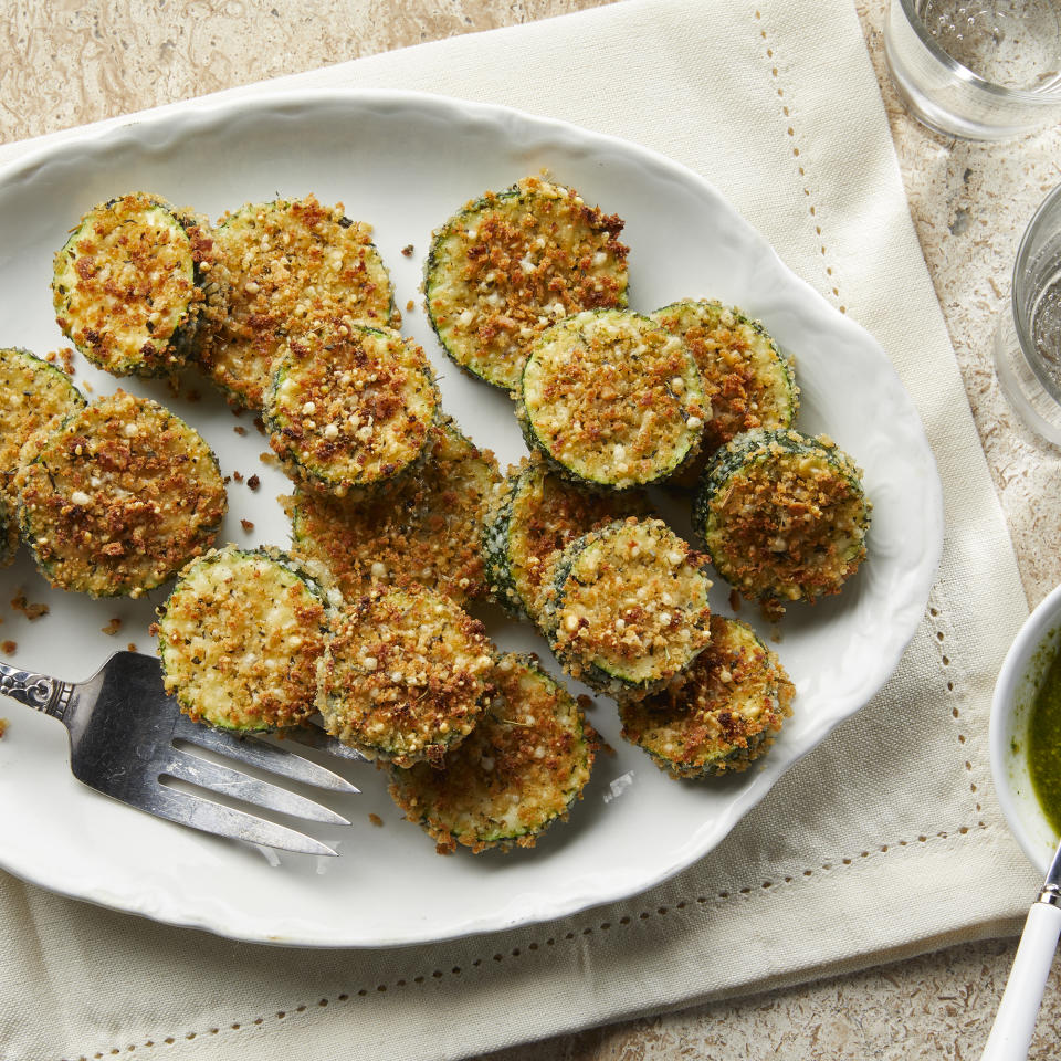 <p>These oven-fried panko- and Parmesan-crusted zucchini rounds are crispy on the outside and tender on the inside, with a hint of Parmesan cheese in the crust. Dip them into marinara, pesto or ranch dressing for an irresistible snack or appetizer. <a href="https://www.eatingwell.com/recipe/7994623/oven-fried-panko-parmesan-crusted-zucchini/" rel="nofollow noopener" target="_blank" data-ylk="slk:View Recipe;elm:context_link;itc:0;sec:content-canvas" class="link ">View Recipe</a></p>