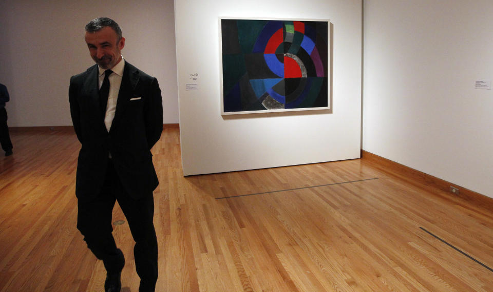 In this photo taken Tuesday, Oct. 9, 2012, Alain Seban, president of the museum at the Pompidor Center, walks past an oil painting by Oil by Sonia Delaunay (Profound Rhythm, 1960), as part of one of two new exhibits featuring art exclusively by women at the Seattle Art Museum, in Seattle. Included in the exhibition is the only U.S. stop for an exhibit from the Pompidou Center in Paris, home of the modern art museum there, of painting, sculpture, drawing, photography and video. The exhibit runs through Jan. 13, 2013. (AP Photo/Elaine Thompson)