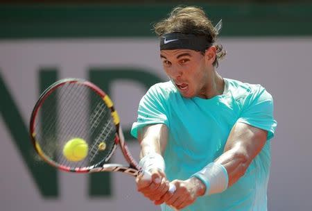 Rafael Nadal of Spain returns the ball to Novak Djokovic of Serbia during their men's singles final match at the French Open Tennis tournament at the Roland Garros stadium in Paris June 8, 2014. REUTERS/Vincent Kessler