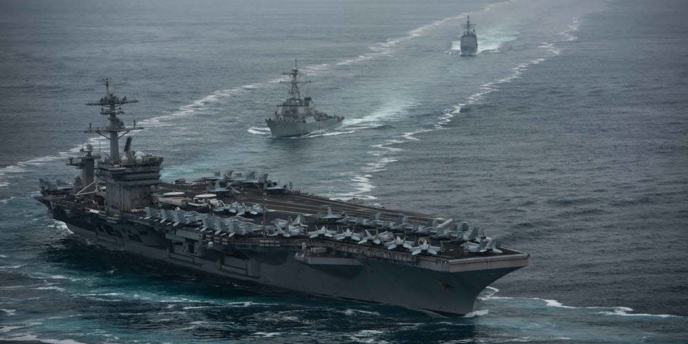 The aircraft carrier USS Theodore Roosevelt (CVN 71), front, the Arleigh Burke-class guided-missile destroyer USS Russell (DDG 59), center, and the Ticonderoga-class guided-missile cruiser USS Bunker Hill (CG 52) transit in formation.