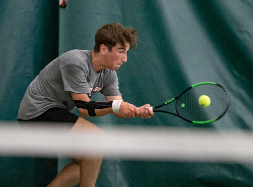 Auburn's Drew Licari hits the ball during the Class 2A Auburn boys tennis sectional Saturday at Boylan Tennis Center.