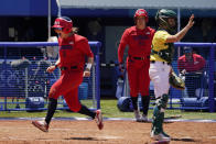 United States' Haylie McCleney, left, celebrates after scoring the game winning run behind Australia's Belinda White, left, in the eighth inning of a softball game at the 2020 Summer Olympics, Sunday, July 25, 2021, in Yokohama, Japan. (AP Photo/Sue Ogrocki)