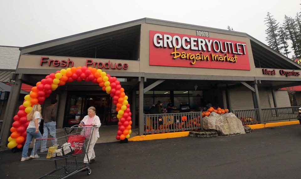 Shoppers exit and enter the newly opened Grocery Outlet in Kingston, Wash. on Thursday, Oct. 12, 2023.