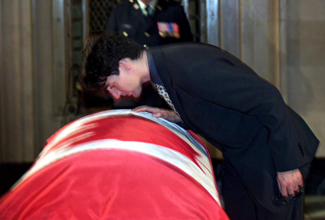 Justin Trudeau leans over and kisses the casket of his father former prime minister Pierre Trudeau during the lying-in-state ceremony at Montreal's city hall Monday, Oct. 2, 2000. A state funeral will be held Tuesday in Montreal. (CP PHOTO/Paul Chiasson)
