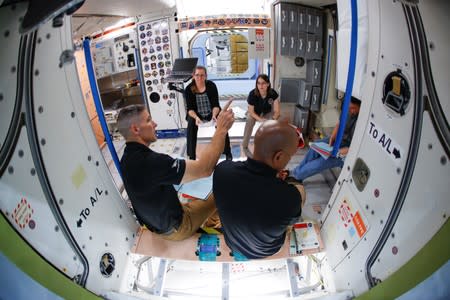 NASA commercial crew astronauts Michael Hopkins and Victor Glover run through a training session at a replica International Space Station (ISS) at the Johnson Space Center in Houston, Texas