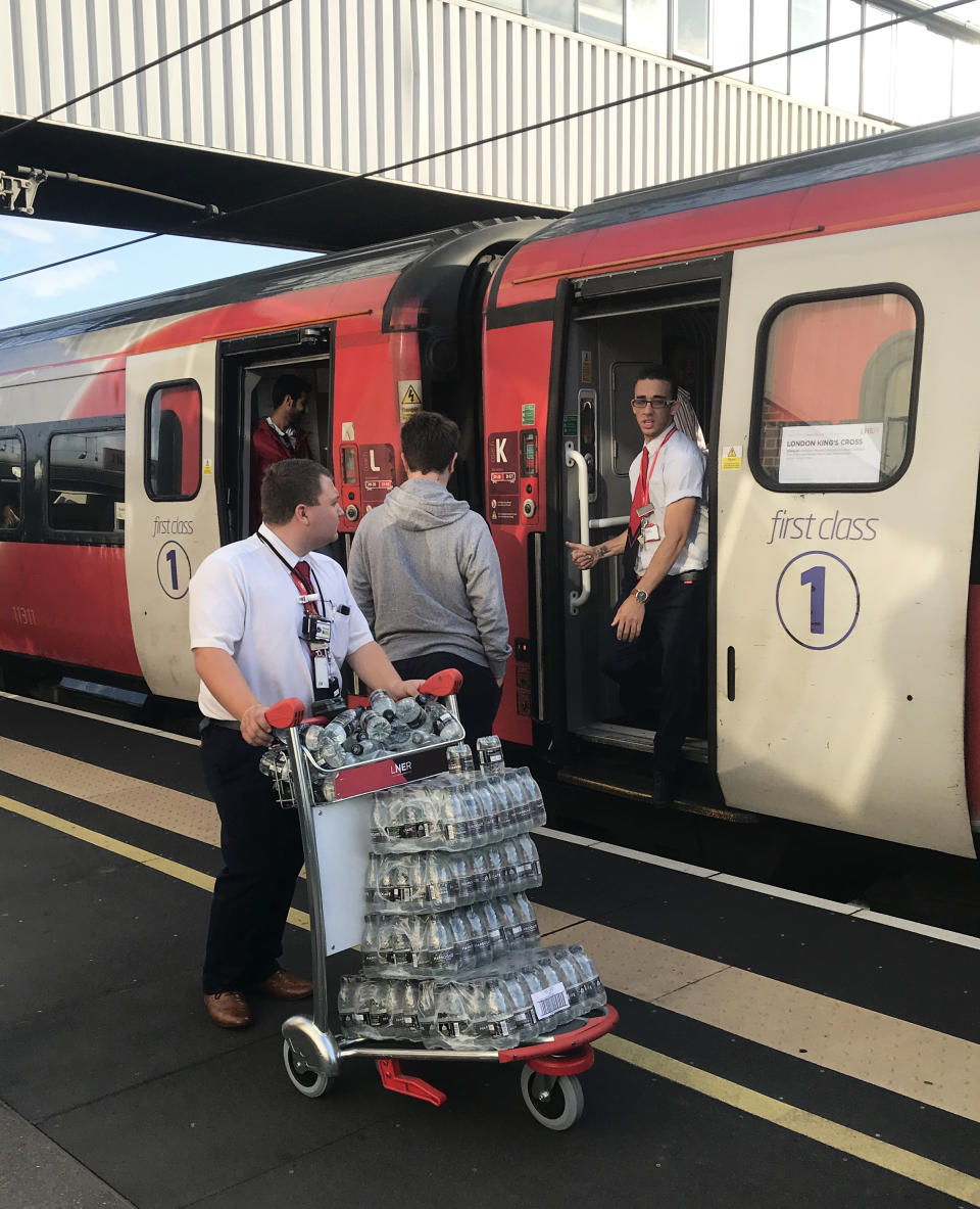 A LNER staff member pushes a trolley of bottled water at Peterborough station, as passengers wait for news during travel disruption on the East Coast mainline, after a large power cut has caused �apocalyptic� rush-hour scenes across England and Wales, with traffic lights down and trains coming to a standstill.