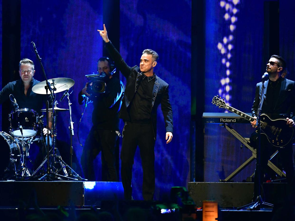 Robbie Williams performs on stage at the Brit Awards: PA