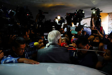 Mexican President-elect Andres Manuel Lopez Obrador (back to camera) speaks to journalists in Mexico City, Mexico, July 6, 2018. REUTERS/Alexandre Meneghini