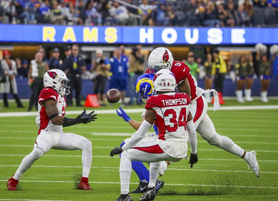 Rams receiver Ben Skowronek (18) bobbles a pass under pressure from three Cardinals defenders.