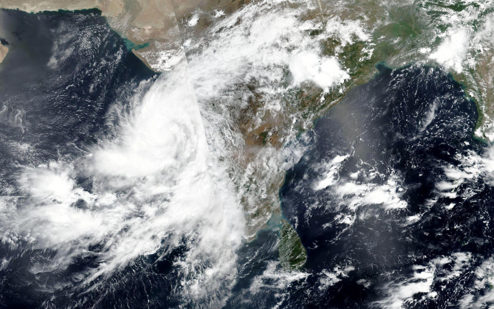 This Tuesday, June 2, 2020, satellite image released by NASA shows Cyclone Nisarga roaring toward the western coast of India. The cyclone is forecast to make landfall Wednesday, June 3, 2020, afternoon on the country's west coast near Mumbai, a coastal city home to 18.4 million people and known for the Bollywood film industry. Mumbai hasn't been hit by a cyclone in more than a century, raising concern about its readiness. (NASA Worldview, Earth Observing System Data and Information System (EOSDIS) via AP)