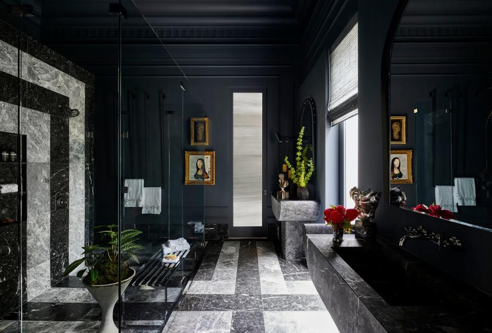 An oversized glassed-in shower with Kohler faucets and a marble wall, left, is a highlight of designer Donna Mondi's James Bond-theme bathroom on the ground floor of the Kips Bay Decorator Show House Palm Beach.