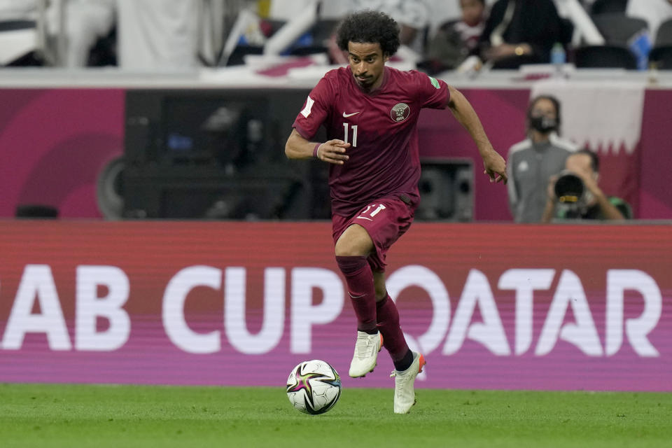 FILE - Qatar's Akram Afif is in action during the group A Arab Cup soccer match between Qatar and Bahrain at the Al Bayt stadium in Al Khor, Qatar, Tuesday, Nov. 30, 2021. (AP Photo/Darko Bandic, File)