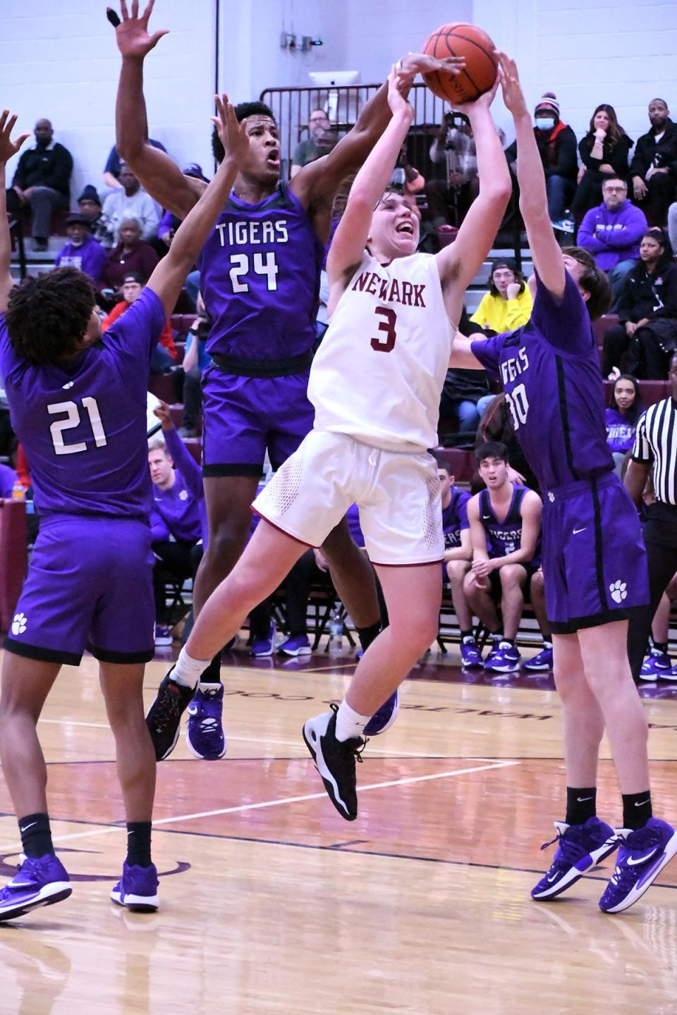 Newark sophomore Steele Meister fights through the Pickerington Central defense, scoring on the play and drawing a foul against Alex "Sonny" Styles (24) at Jimmy Allen Gymnasium on Friday, Jan. 21, 2022. The host Wildcats fell 54-42 in an Ohio Capital Conference-Buckeye Division showdown.