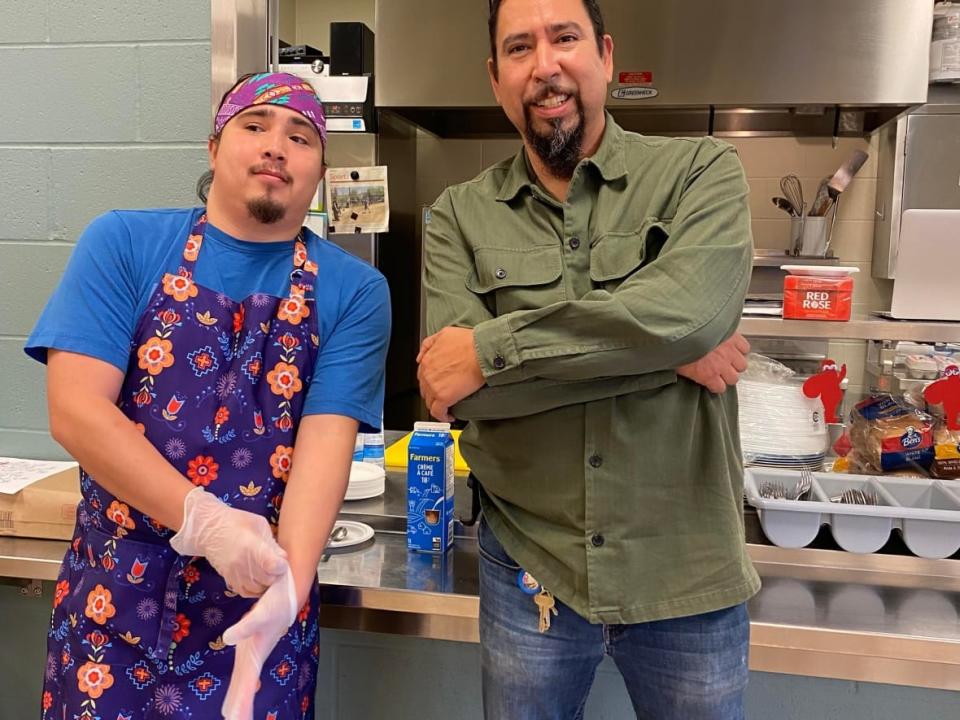 Jeff Ward, right, and his son Oonig Paul-Ward have so far volunteered over 40 hours of their time at the Membertou comfort centre. (Submitted by Jeff Ward - image credit)
