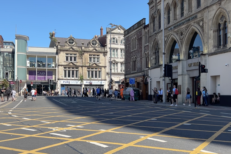 A crowd walking along buildings in Cardiff's Saint Mary Street