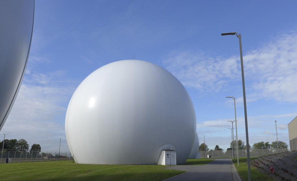 Satellite dishes inside Kevlar domes at the Kester Satellite Ground Station in Kester, Belgium, Thursday, Oct. 15, 2020. This week, the site at Kester, which has been in use for decades but was totally overhauled in 2014, is set to fall under a new orbit, when NATO announces that it is creating a space center to help manage satellite communications and key parts of its military operations around the world. (AP Photo/Lorne Cook)