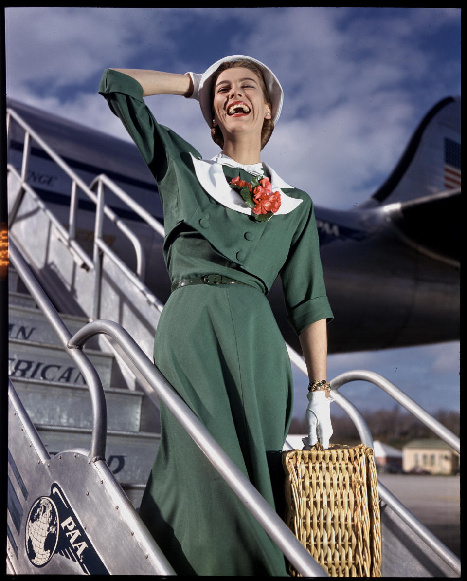 A model poses walking off the Pan American Clipper 'Challenge' Lockheed 1049 airliner circa 1947.