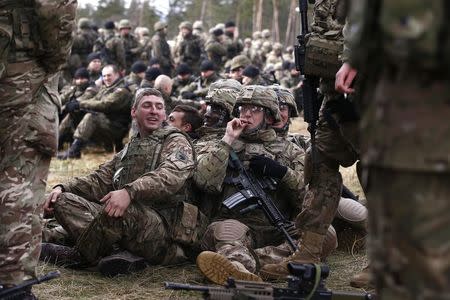 REFILE- CORRECTING DATE U.S. and British soldiers wait for the welcoming ceremony at polygon near Orzysz, Poland, April 13, 2017. REUTERS/Kacper Pempel