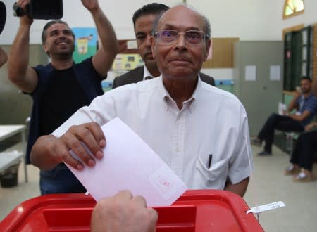 Former Tunisian president and presidential candidate, Moncef Marzouki, casts his vote at a polling station during presidential election in Sousse