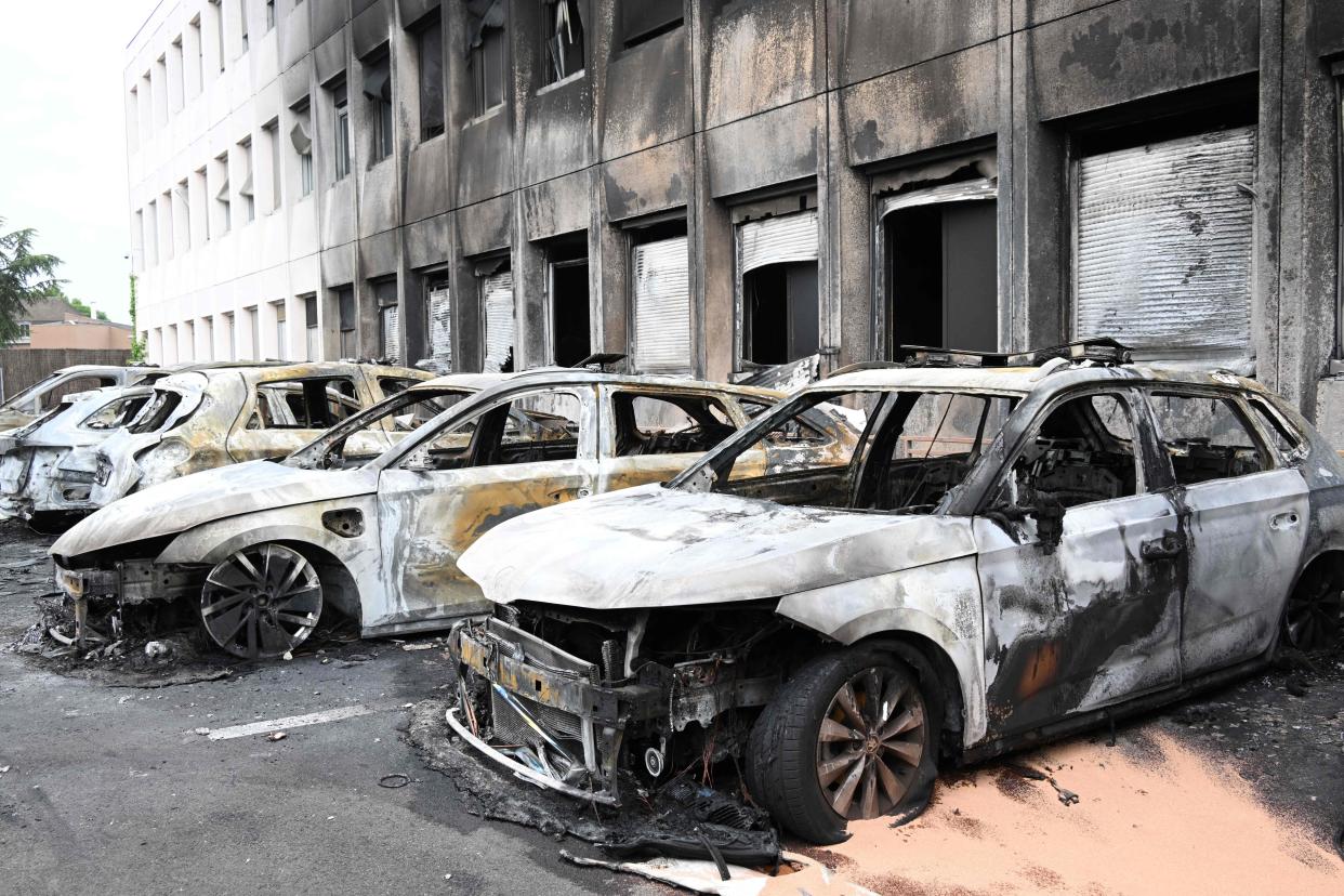 Seven burnt out vehicles are seen outside the municipal police building following violence in Neuilly-sur-Marne on 29 June 2023 (AFP via Getty Images)