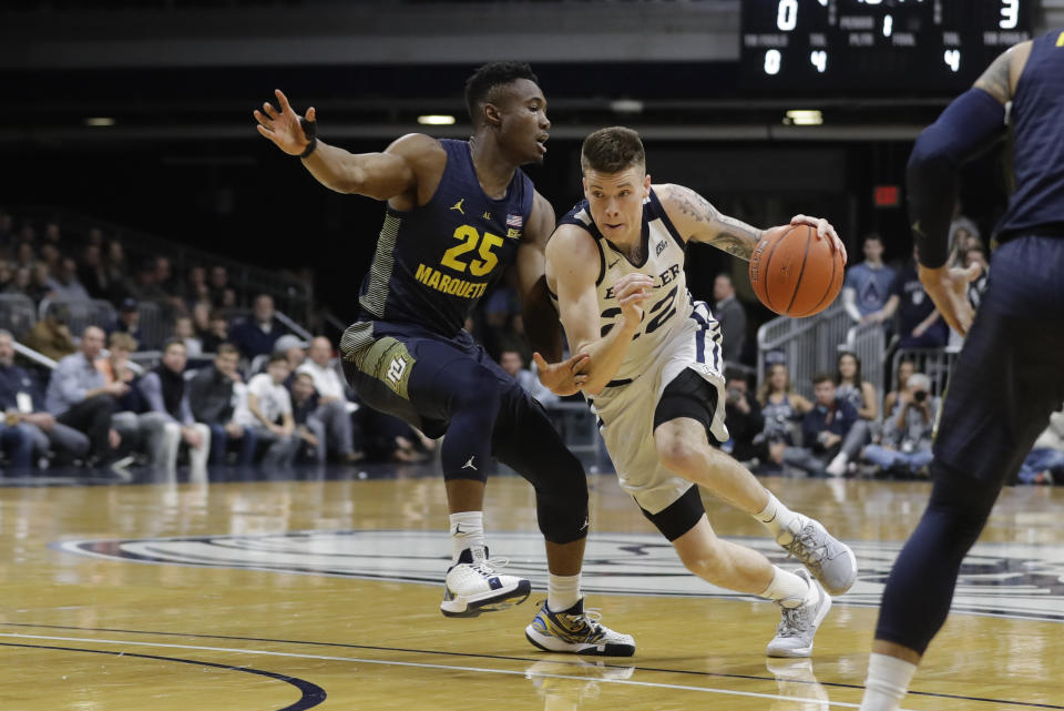 Butler's Sean McDermott (22) goes to the basket against Marquette's Koby McEwen (25) during the first half of an NCAA college basketball game, Friday, Jan. 24, 2020, in Indianapolis. (AP Photo/Darron Cummings)