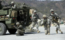 FILE - In this March 25, 2015, file photo, U.S. Army soldiers from the 25th Infantry Division's 2nd Stryker Brigade Combat Team and South Korean soldiers take their position during a demonstration of the combined arms live-fire exercise as a part of the annual joint military exercise Foal Eagle between South Korea and the United States at the Rodriquez Multi-Purpose Range Complex in Pocheon, South Korea. Ahead of the second summit between U.S. President Donald Trump and North Korean leader Kim Jong Un, some observers say there is an uncertainty over the future of the decades-long military alliance between Washington and Seoul. (AP Photo/Lee Jin-man, File)