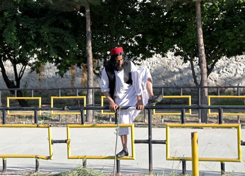 A newly freed Taliban prisoner climb fence at Pul-i-Charkhi prison, in Kabul, Afghanistan