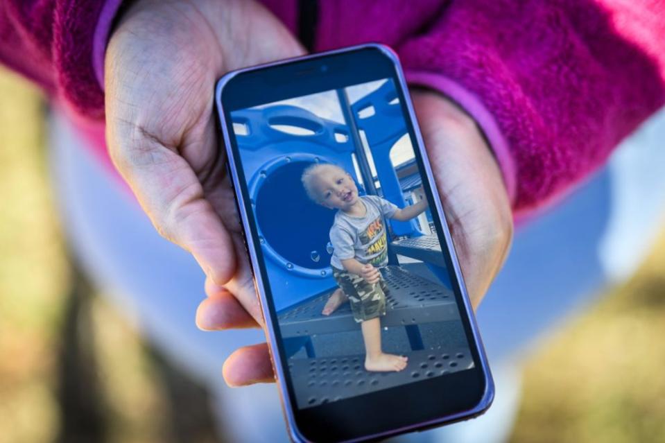 A photo of a young child on a phone screen