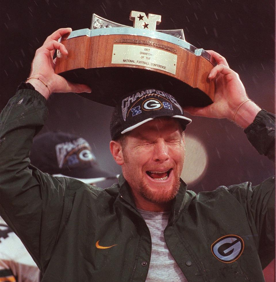 An emotional Green Bay Packers quarterback Brett Favre hoists the George Halas Trophy after his team beat the San Francisco 49ers Sunday, Janaury 11, 1998 at 3Com Park.