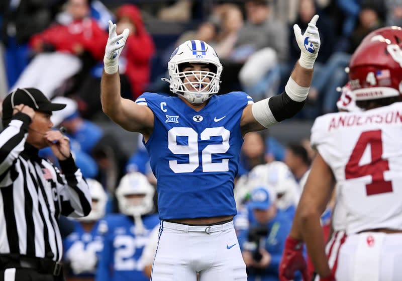 BYU defensive end Tyler Batty encourages fans as BYU and Oklahoma play at LaVell Edwards Stadium in Provo, Nov. 18, 2023.