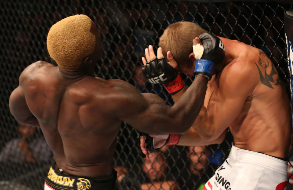 Melvin Guillard punches Donald Cerrone during their lightweight bout at UFC 150 inside Pepsi Center on August 11, 2012 in Denver, Colorado. (Photo by Nick Laham/Zuffa LLC/Zuffa LLC via Getty Images)