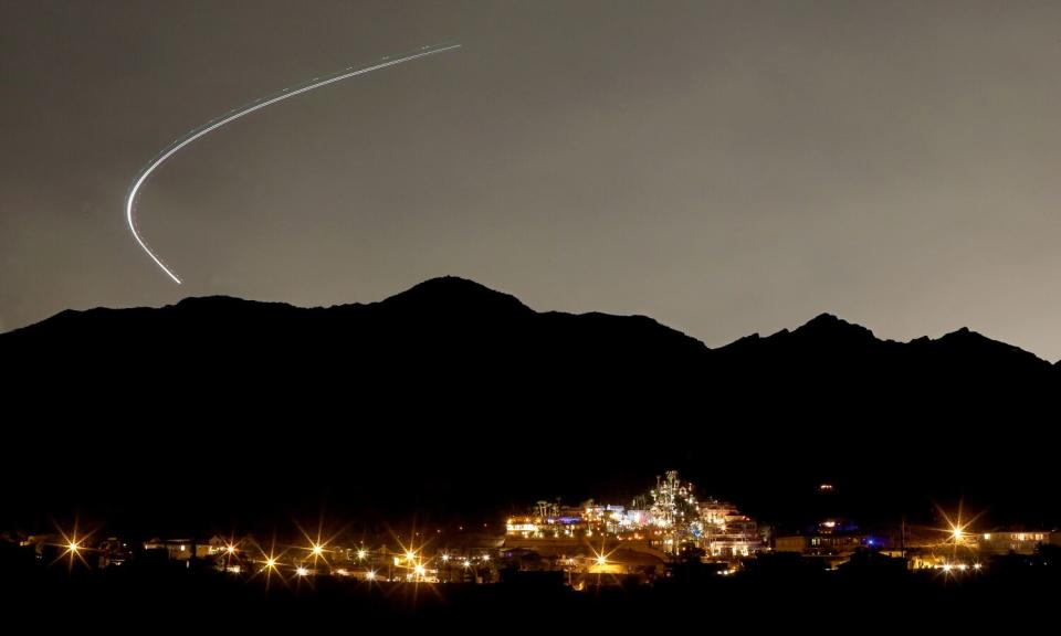 A plane taking off from the Las Vegas airport arcs over luxury homes in Boulder City.
